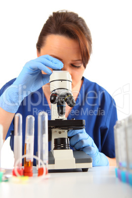 Female Researcher looking into a microscope