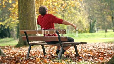 man relaxing on bench
