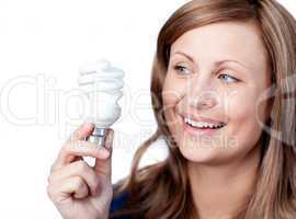 Smiling young woman holding a light bulb