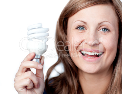 Cheerful woman holding a light bulb