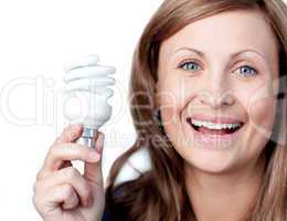 Cheerful woman holding a light bulb