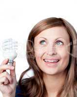 Delighted woman holding a light bulb