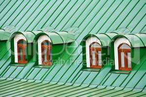 Roof dormers on the roof covered with green iron plates