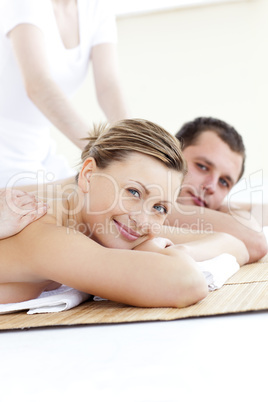 Charming couple smiling at the camera having a back massage