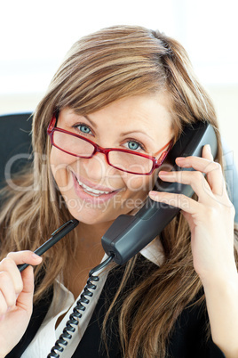 Ambitious businesswoman talking on phone smiling at the camera