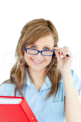 Jolly young woman holding a book smiling at the camera