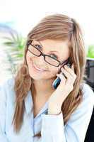 Charming businesswoman talking on phone smiling at the camera