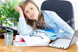 Bored businesswoman sitting at her desk