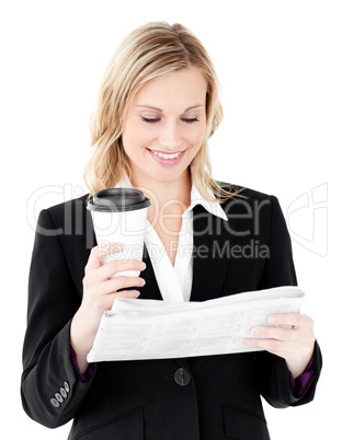 Happy businesswoman reading the newspaper holding coffee