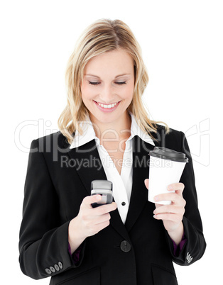 Beautiful businesswoman sending a text holding coffee