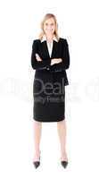 Self-assured businesswoman with folded arms smiling at the camer