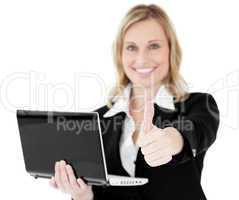 Positve businesswoman holding a laptop  thumb up