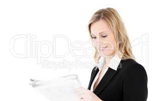 Friendly young businesswoman reading newspaper
