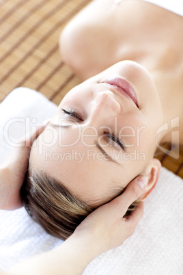 Positive blond woman receiving a head massage