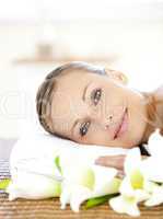 Pretty woman lying on a massage table looking at the camera