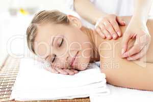 Radiant woman receiving an acupuncture treatment