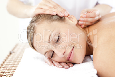 Relaxed woman receiving an acupuncture treatment