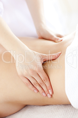 Close-up of a young woman receiving a back massage