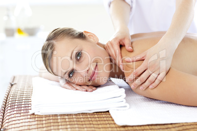 Jolly young woman receiving a back massage