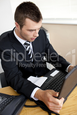 Shocked businessman looking at this laptop