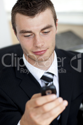 Smiling young businessman sending a message