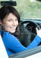 Glowing female teenager sitting in her new car