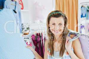 Close-up of a smiling woman doing shopping looking at the camera