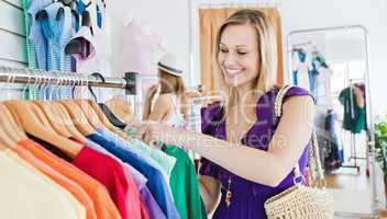 Delighted young woman choosing clothes
