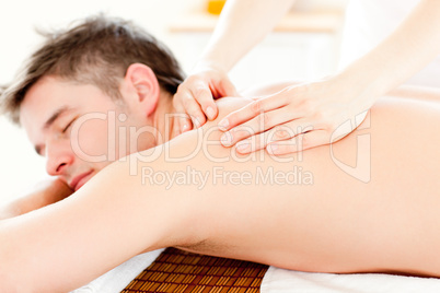 Positive young man having a back massage