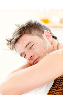 Portrait of a relaxed man lying on a massage table