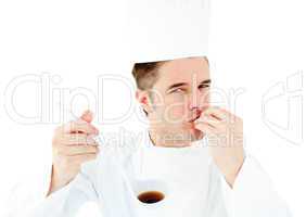 Caucasian young cook tasting a delicious soup