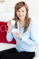 Self-assured blond businesswoman holding a cup