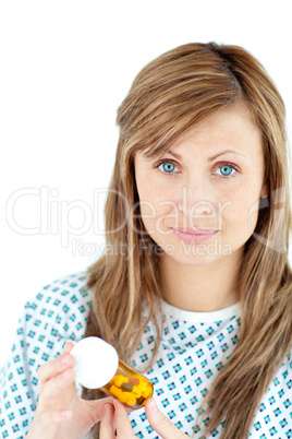 Sick young female patient holding pills