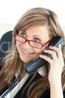 Bright young businesswoman talking on phone wearing glasses