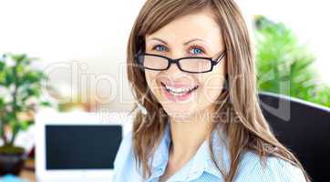 Glwoing caucasian businesswoman sitting in her office