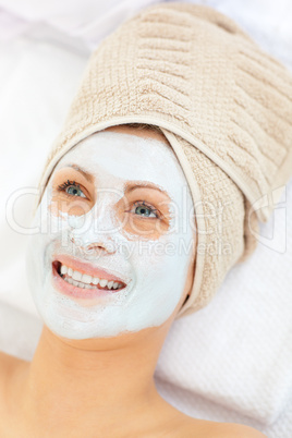 Glowing caucasian woman with white cream on her face