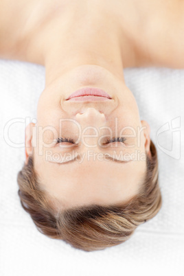 Isolated young woman lying in a spa center