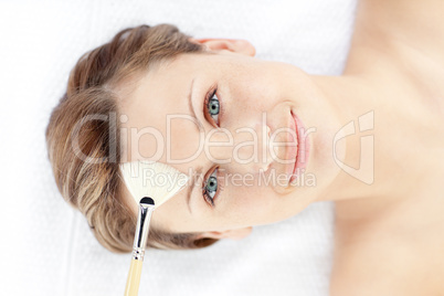 Bright young woman receiving a beauty treatment