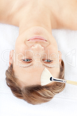 Delighted young woman receiving a beauty treatment