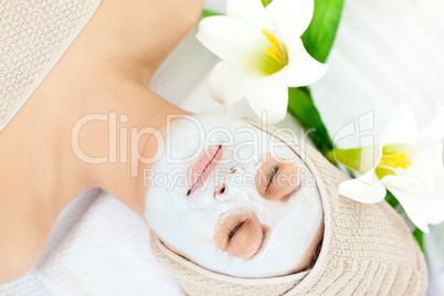 Resting woman with white cream on her face