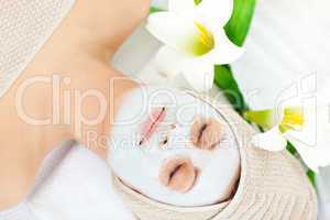 Resting woman with white cream on her face
