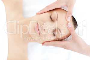 Caucasian young woman receiving a facial massage