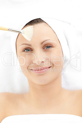 Merry young woman receiving a beauty treatment