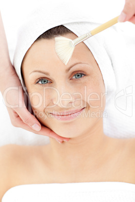 Portrait of a captivating woman receiving a beauty treatment