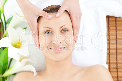 Glowing woman having a head massage