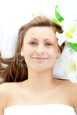 Pretty young woman lying on a massage table