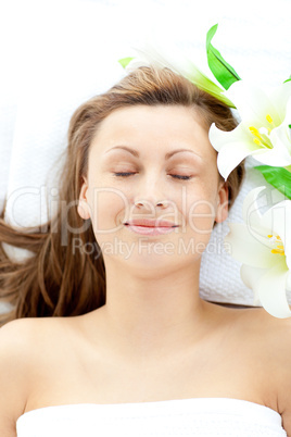 Positive young woman lying on a massage table