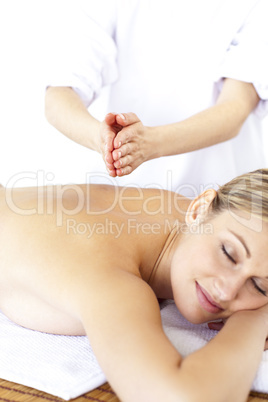 Resting young woman receiving a tapping massage
