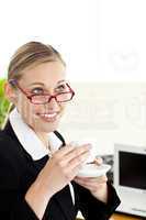Charismatic young businesswoman drinking a coffee
