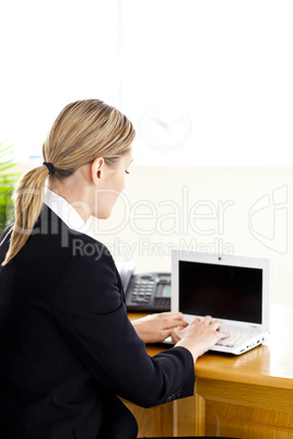 Ambitious businesswoman working at the laptop